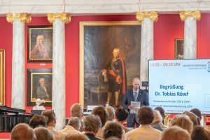 Man sieht die Aula der Universität Greifswald und die Köpfe der Besucher zum Festakt 100 Jahre Sternwarte Greifswald