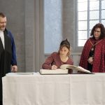 Traditionell schreibt sich eine neue Studentin während der Immatrikulationsfeier in das Ehrenbuch der Universität Greifswald ein.