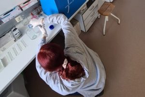 The photo shows Mariia working in the laboratory for her master thesis.